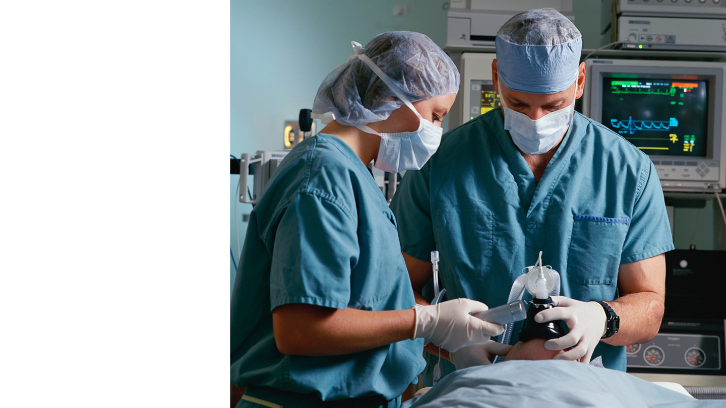 Anesthesiologists working on a patient