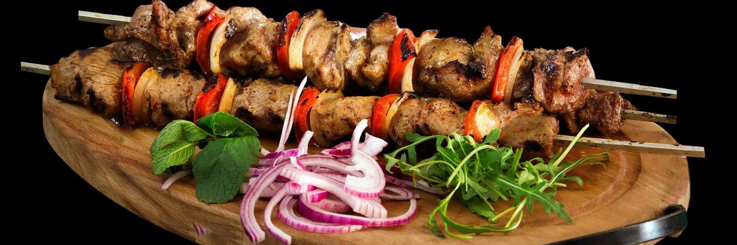 Meat-based kebabs on a plate